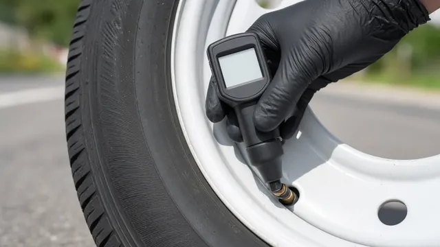 Gloved hand checking trailer tire pressure at the valve stem with a digital gauge